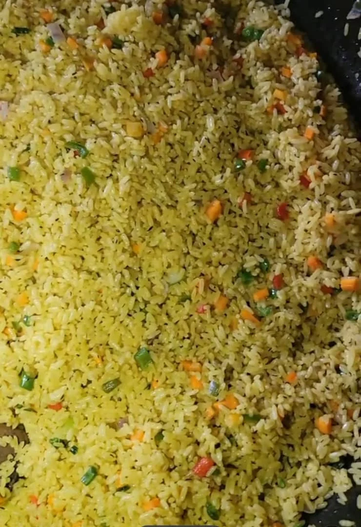 Golden vegetable fried rice being prepared